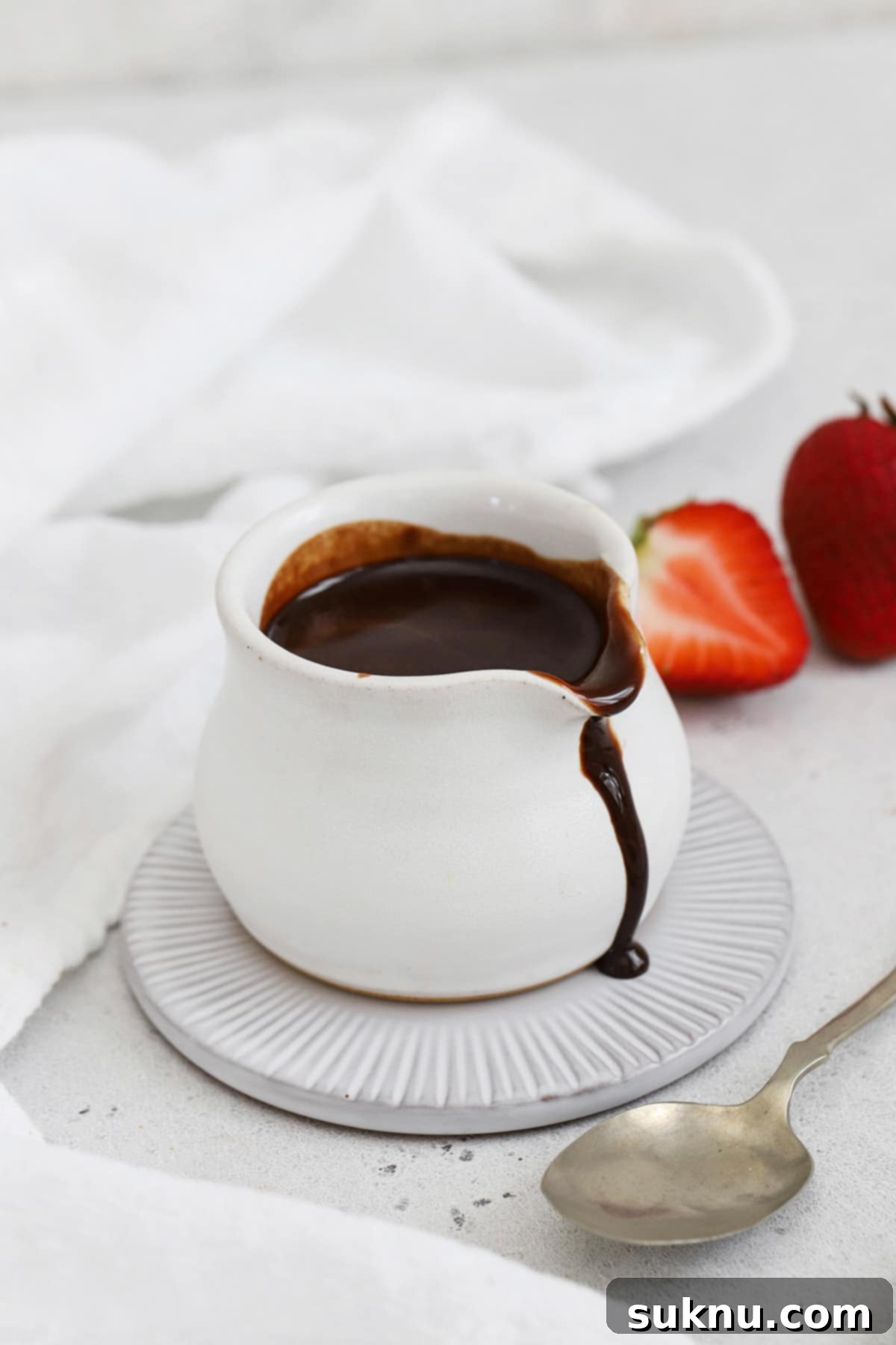 A small white pitcher of homemade chocolate syrup
