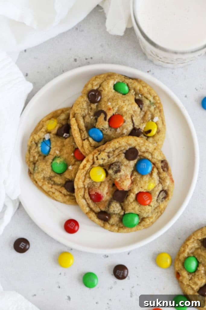 Overhead view of three gluten-free M&M cookies on a plate
