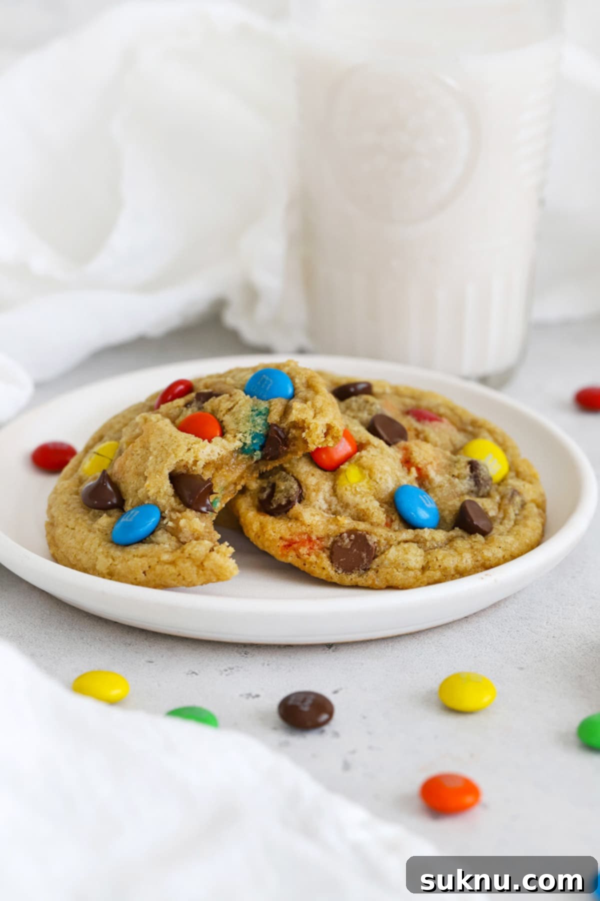 Soft & Chewy Gluten-Free M&M Cookies 5 Front view of vibrant gluten-free M&M cookies stacked on a wire rack, showcasing their colorful candies and perfect bake