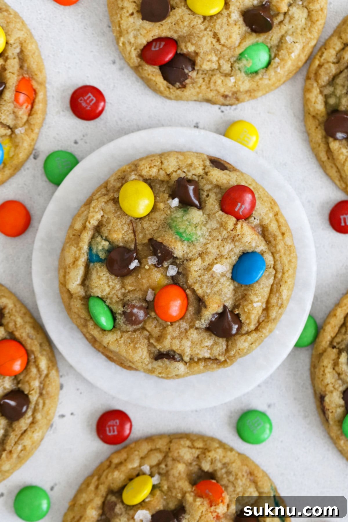 Soft & Chewy Gluten-Free M&M Cookies 7 Overhead view of soft, chewy gluten-free M&M cookies artfully arranged on a cooling rack, ready to be enjoyed