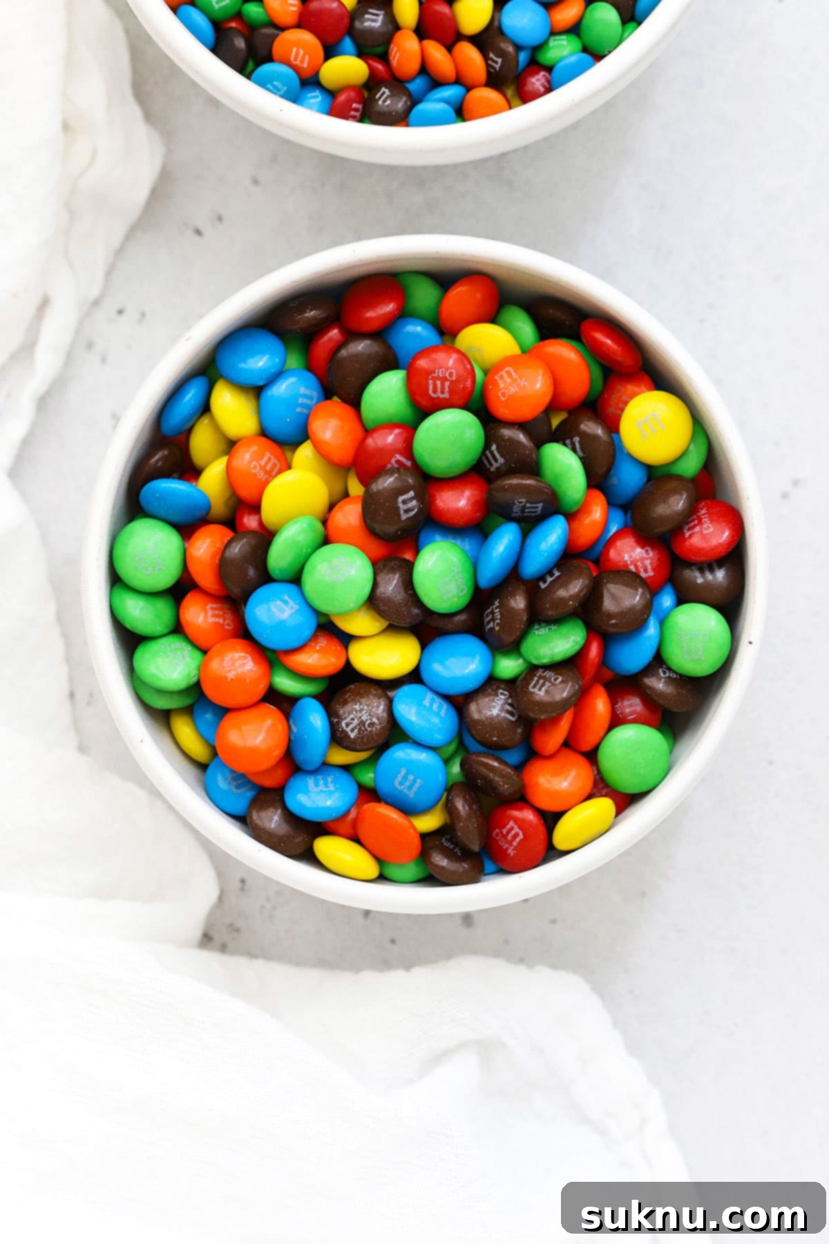 Which M&Ms Are Gluten-Free 2 Overhead bowl of colorful m&m's in a white bowl