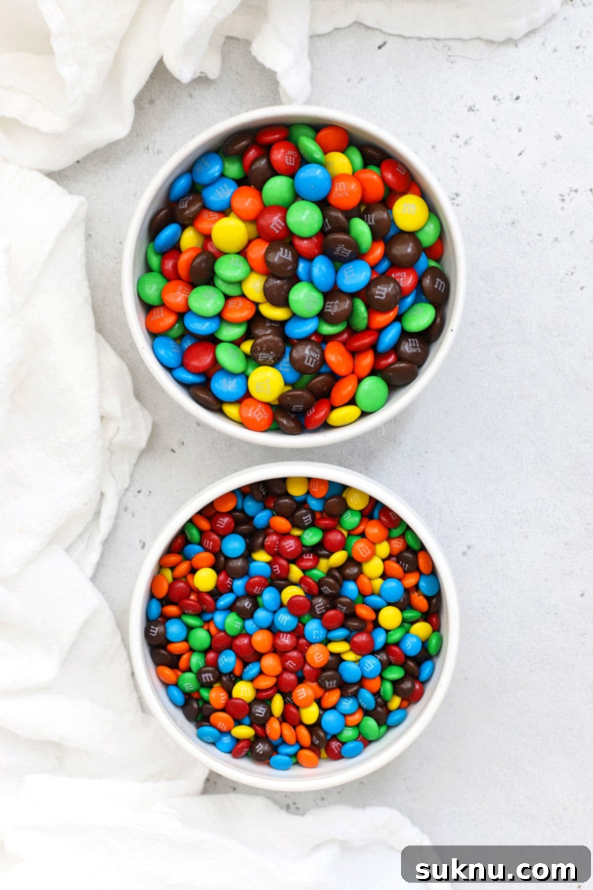 Which M&Ms Are Gluten-Free 3 Overhead view of two bowls of m&m's--one bowl of mini m&m's and one bowl of m&m's