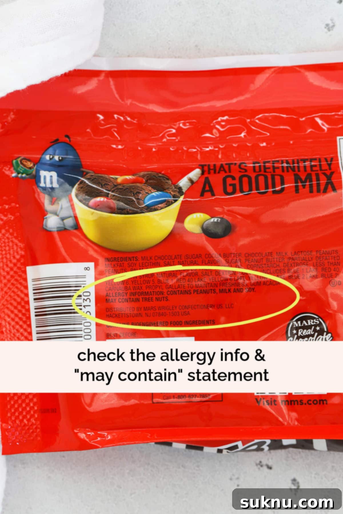 Which M&Ms Are Gluten-Free 4 yellow circle highlighting the "may contain" statement on the nutrition facts of a bag of peanut m&m\