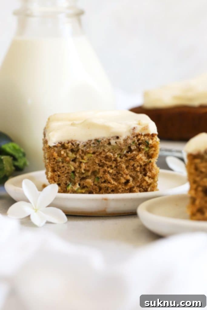 Elegant slices of gluten-free zucchini cake served on a pristine white dessert plate.