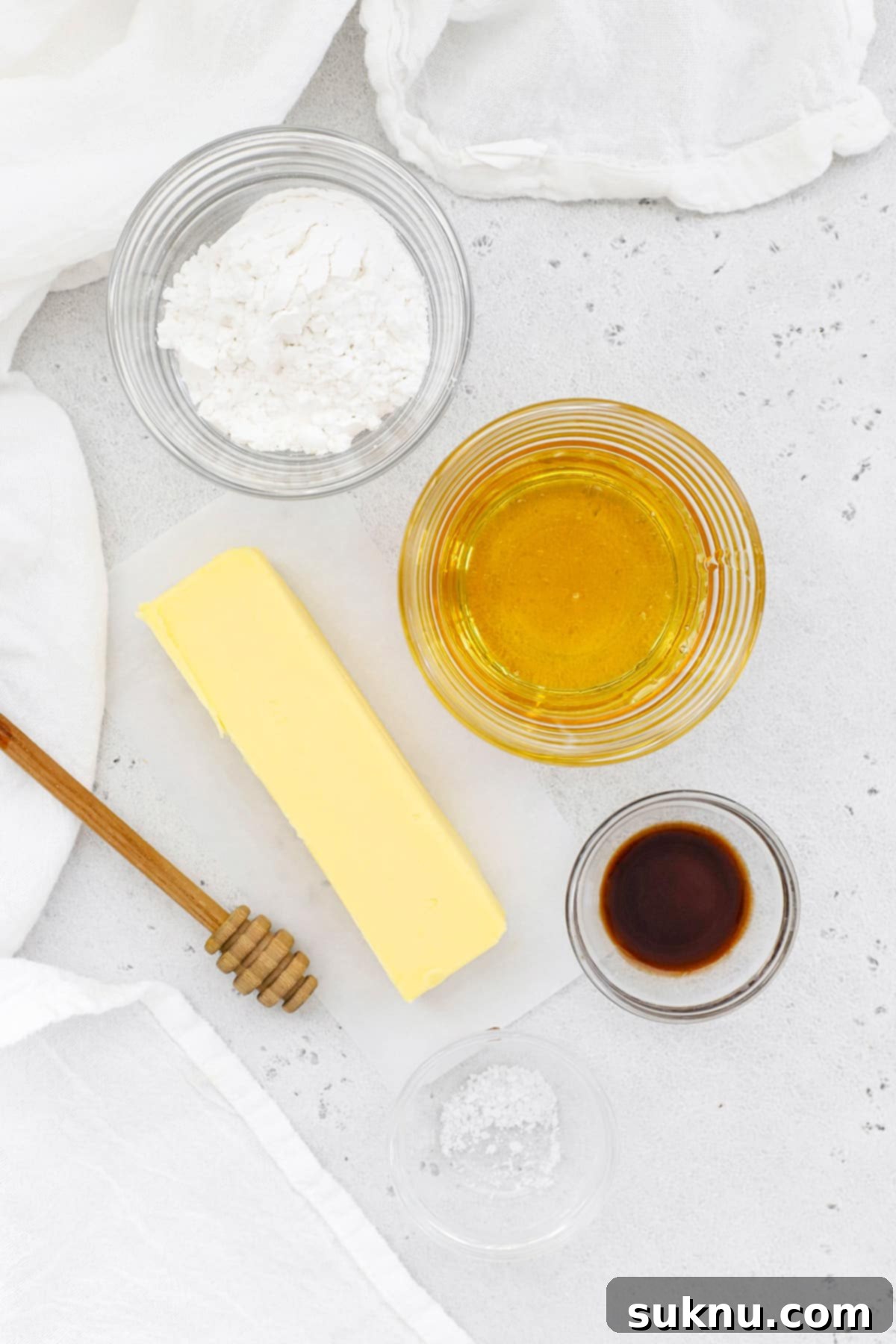 Fluffy Honey Butter Made in Minutes 3 Overhead view of ingredients for homemade honey butter including butter, honey, powdered sugar, vanilla, and salt