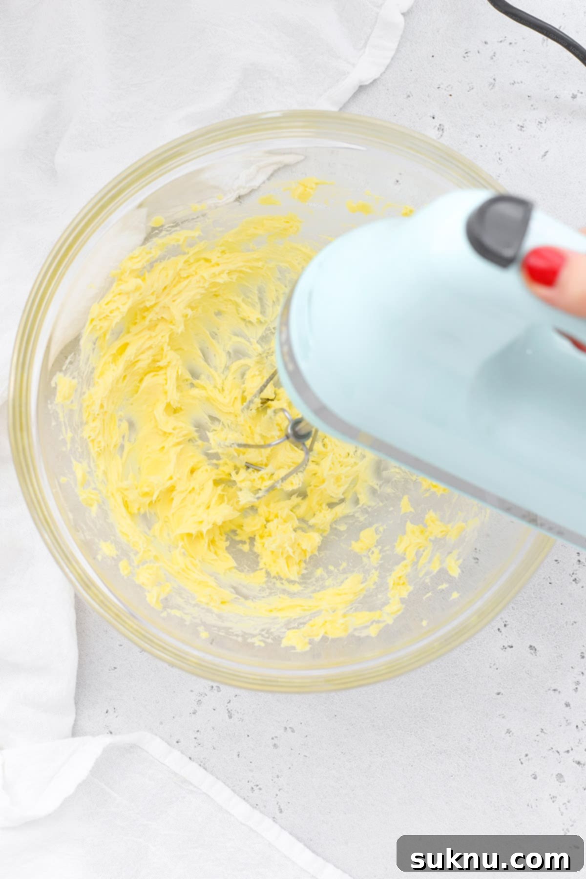 Fluffy Honey Butter Made in Minutes 4 Beating homemade honey butter in a bowl with a hand mixer