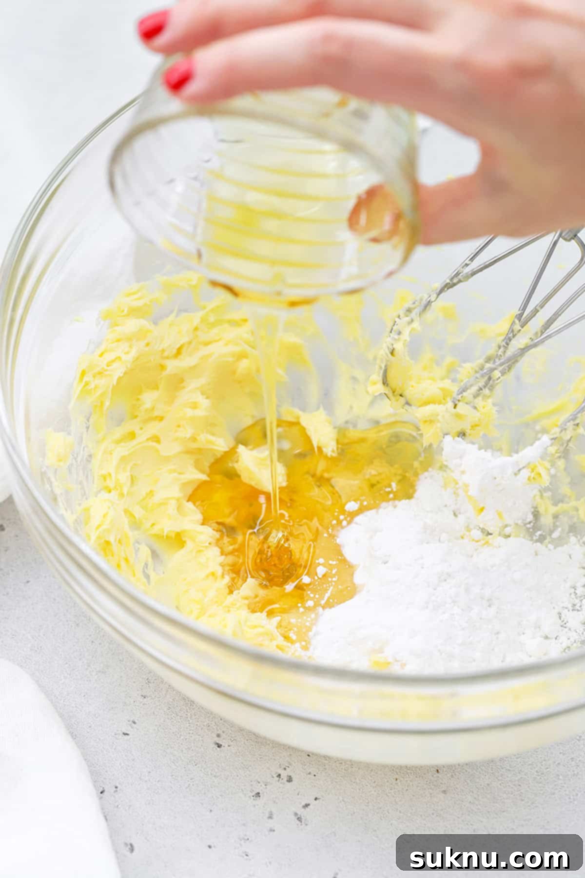 Fluffy Honey Butter Made in Minutes 5 Drizzling honey into butter mixture during the whipping process