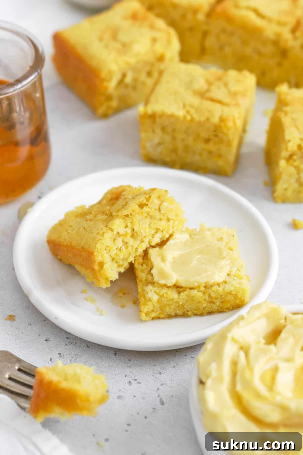 Fluffy Honey Butter Made in Minutes 8 Front view of gluten-free cornbread spread with whipped honey butter