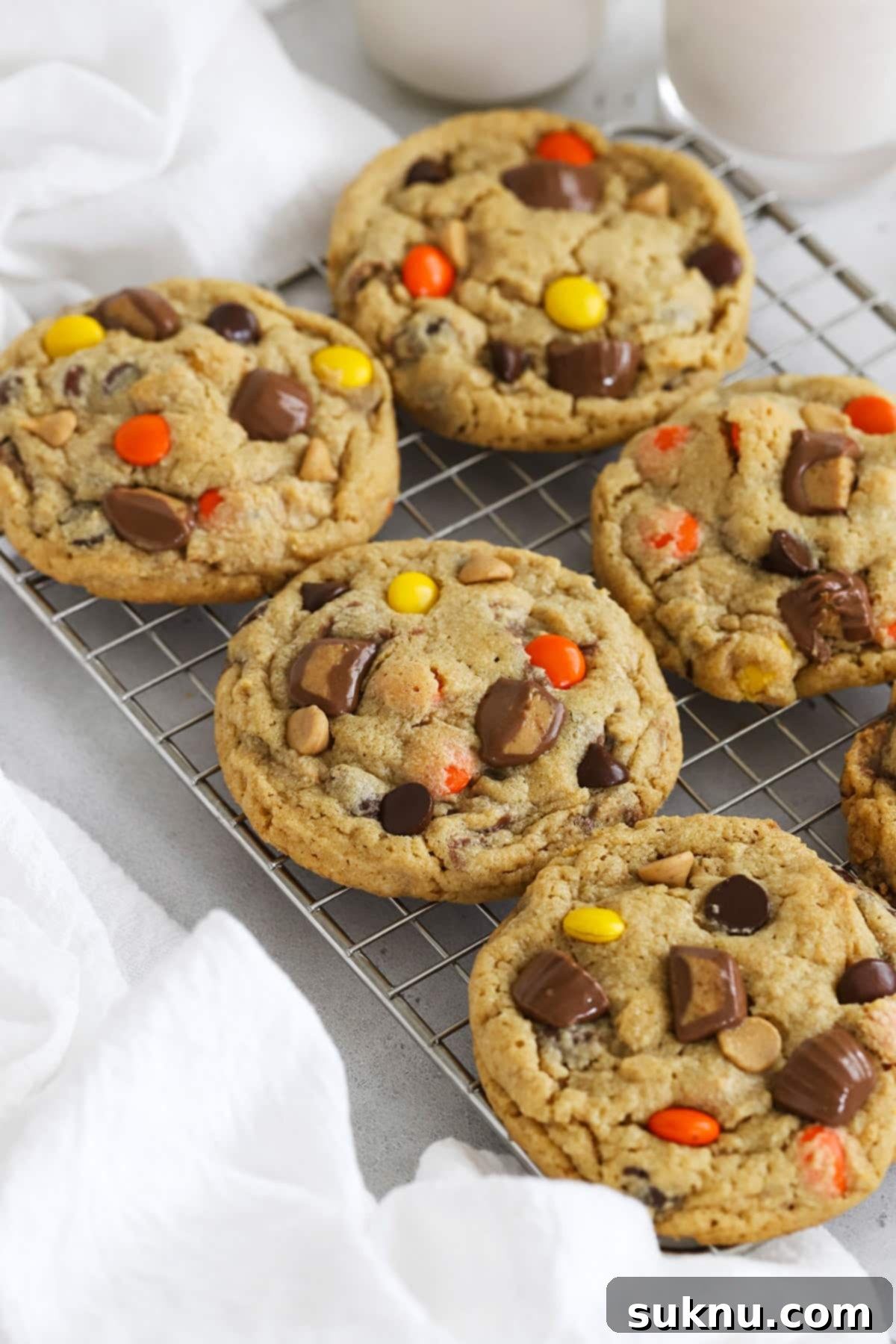 Front view of gluten-free Reese's cookies cooling on a rack, showing their perfect round shape and generous toppings.