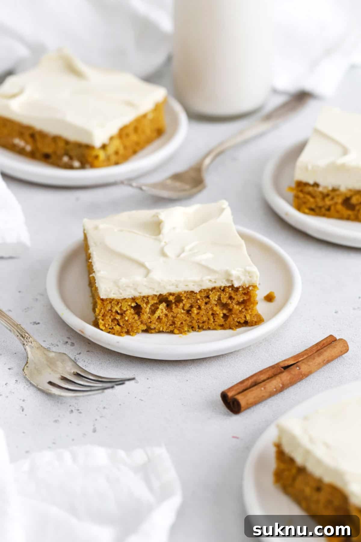 Front view of golden-brown gluten-free pumpkin bars, freshly baked and ready for frosting.