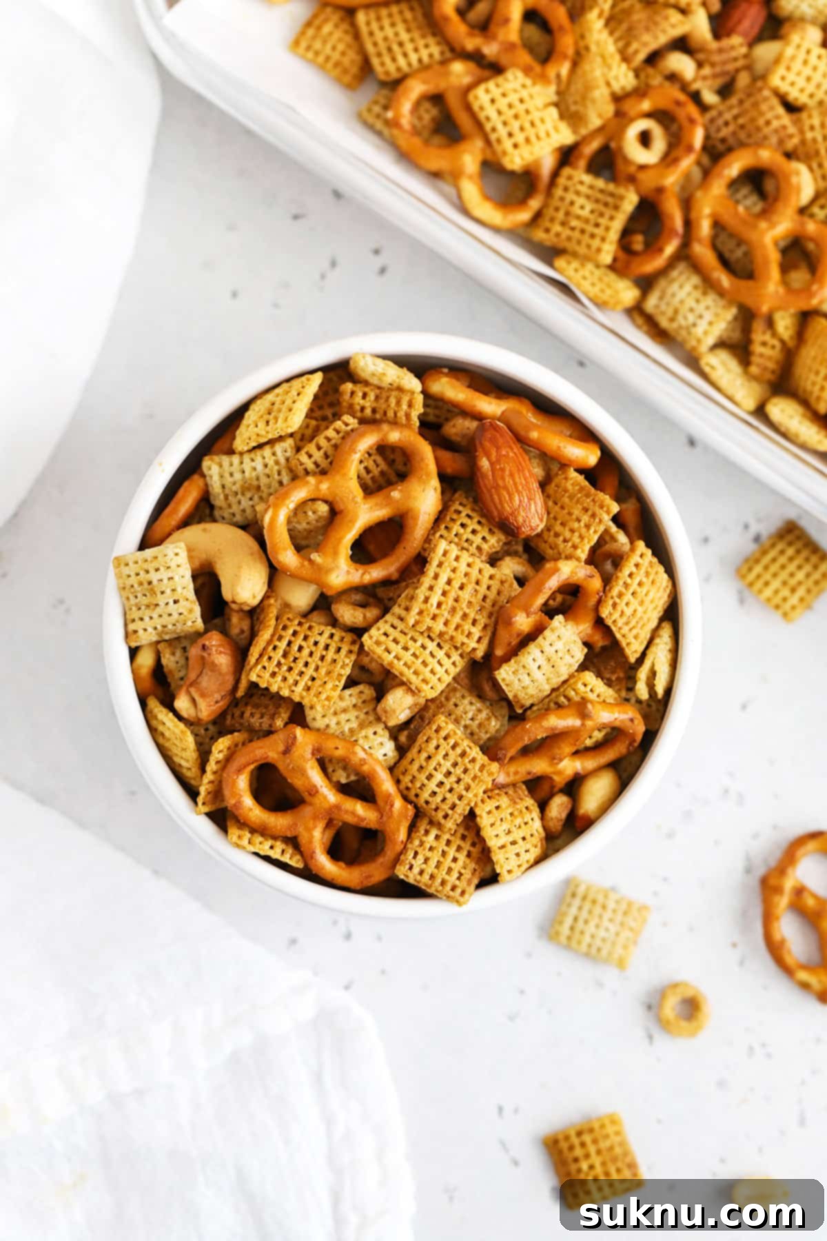 Overhead view of a bowl of easy gluten-free Chex Mix on a white background
