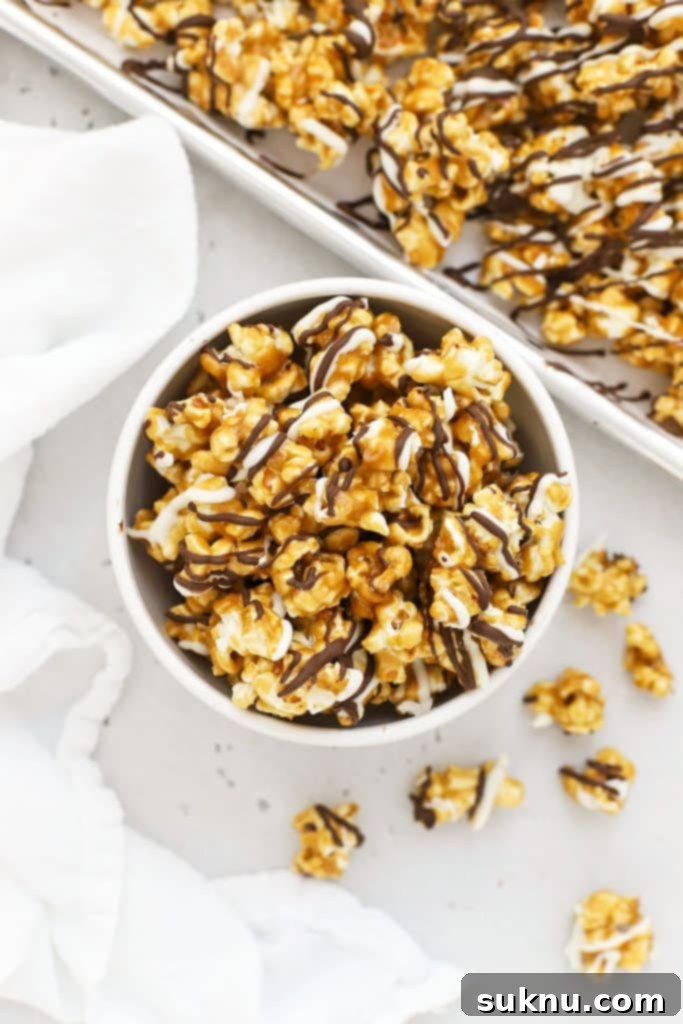 white bowl filled with zebra popcorn drizzled with white chocolate and dark chocolate