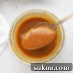 Scooping a spoonful of easy caramel sauce