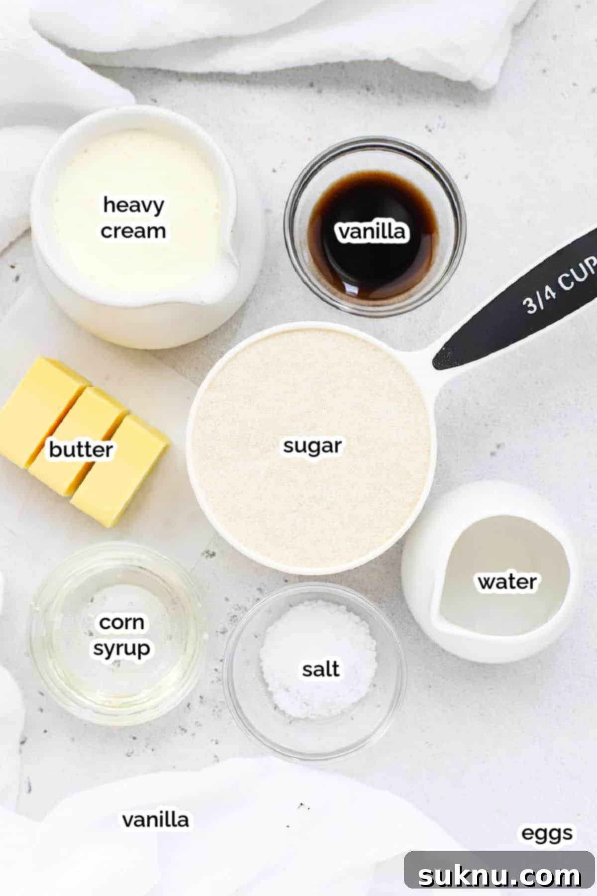 Ingredients for making homemade caramel sauce laid out on a surface.