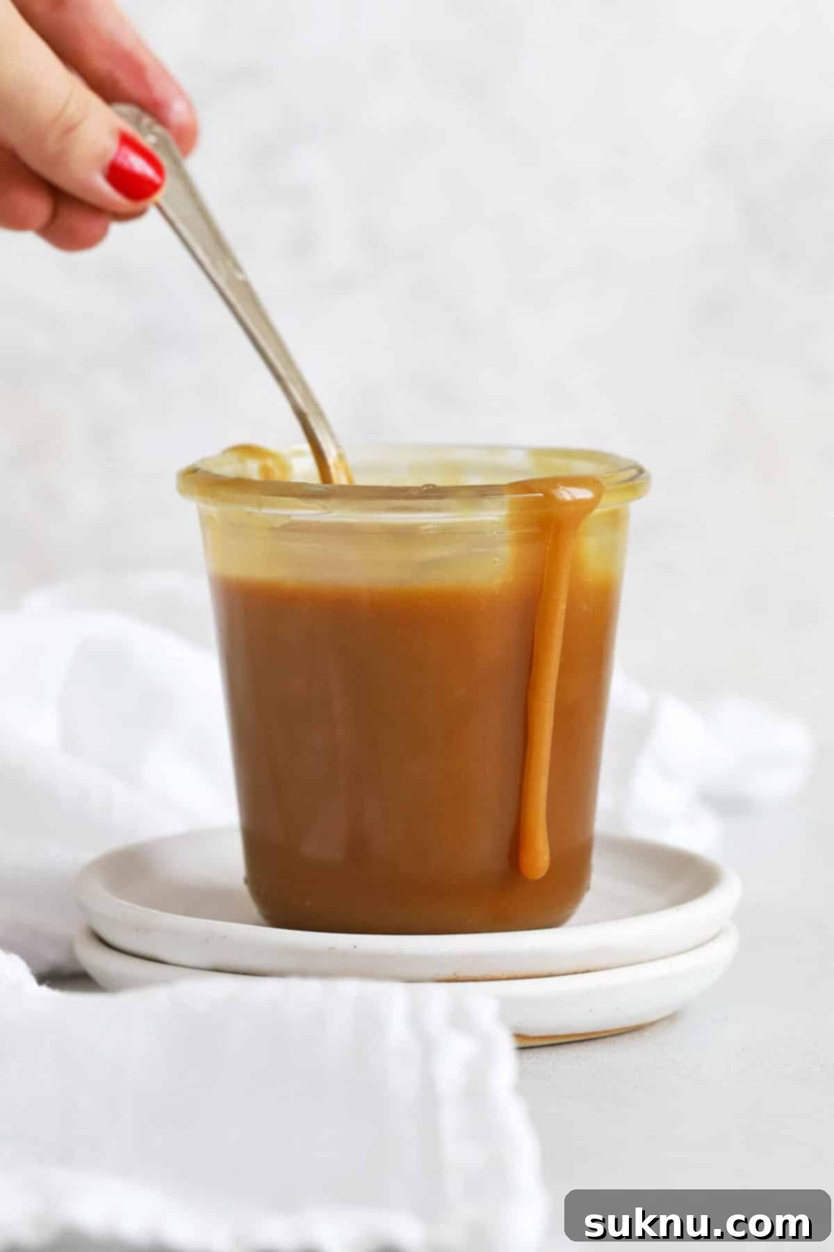 Front view of a jar of easy caramel sauce, showcasing its smooth texture.