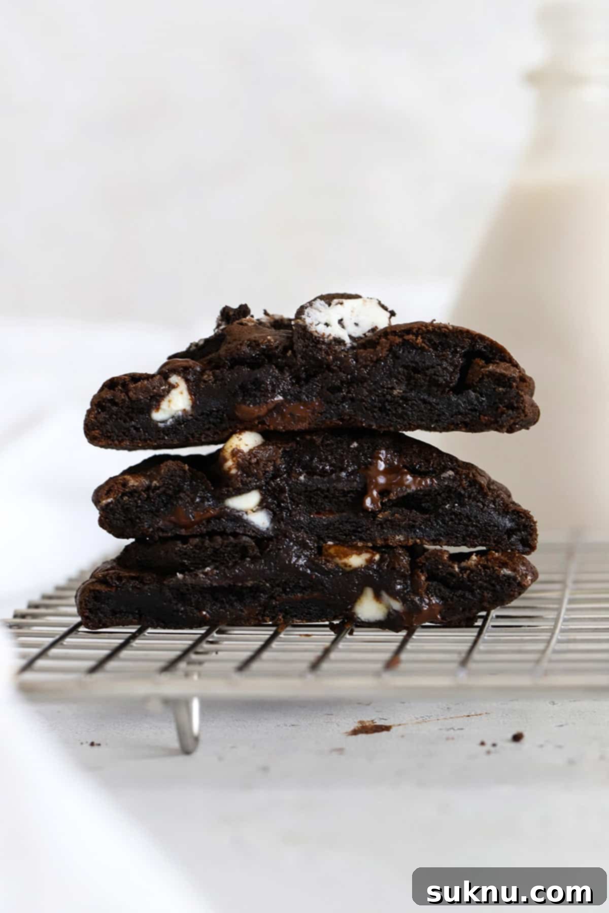 Gluten-Free Chocolate and Cookies & Cream Cookies 7 front view of three gluten-free chocolate cookies & cream cookies cut in half, revealing their fudgy center