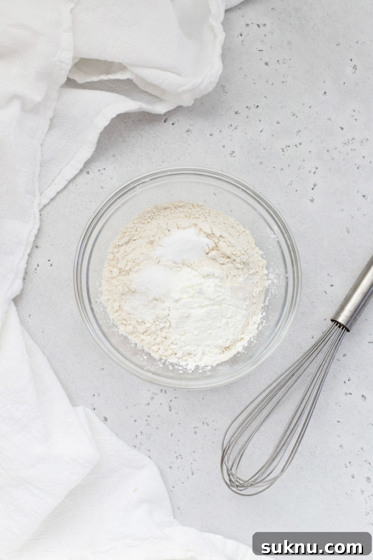 whisking gluten-free flour, cornstarch, baking soda, and salt to combine the dry ingredients