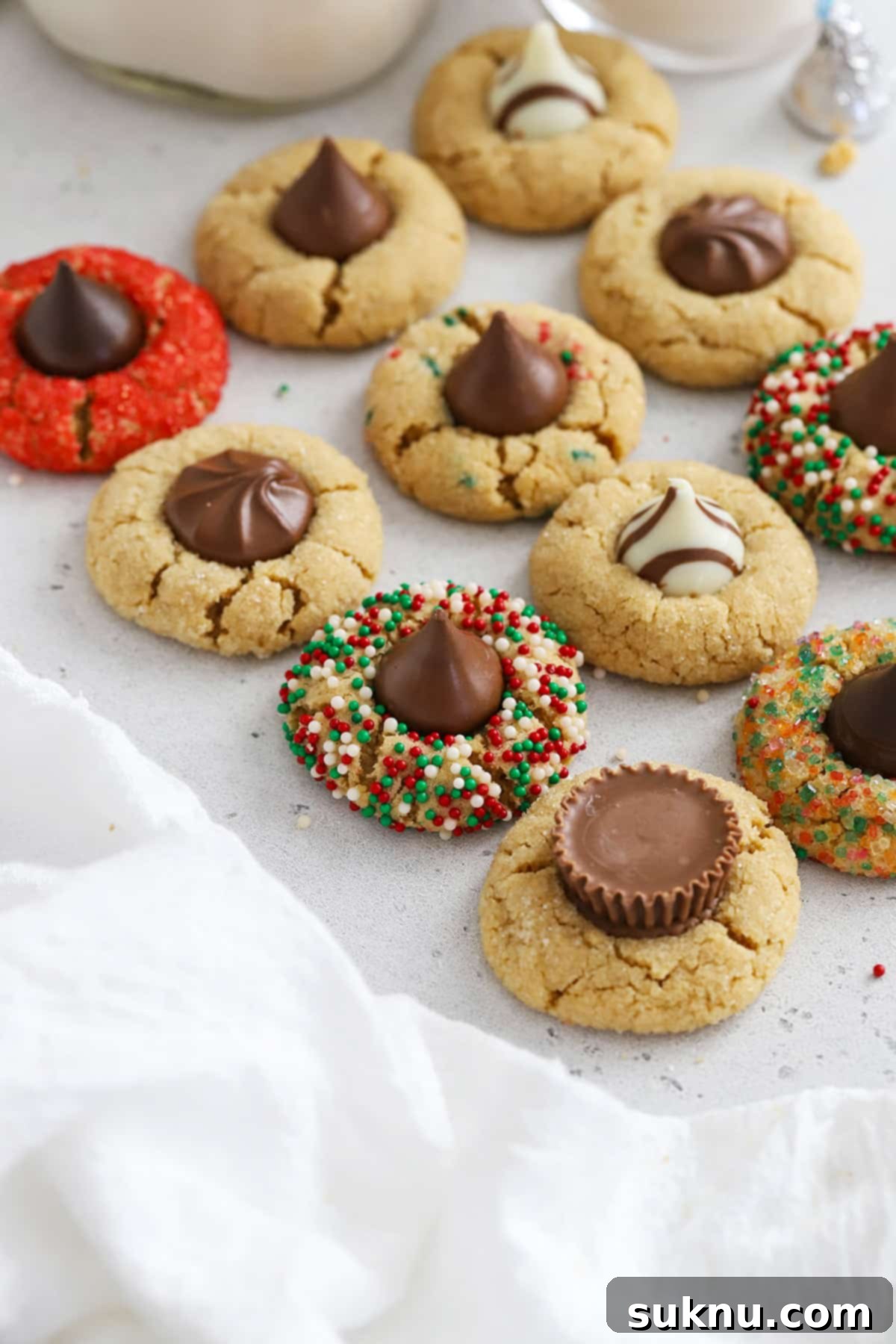 Variations on peanut butter blossoms. Some are made with Hershey's hugs, Brach's chocolate stars, Reeses cups, Rolos, or sprinkles