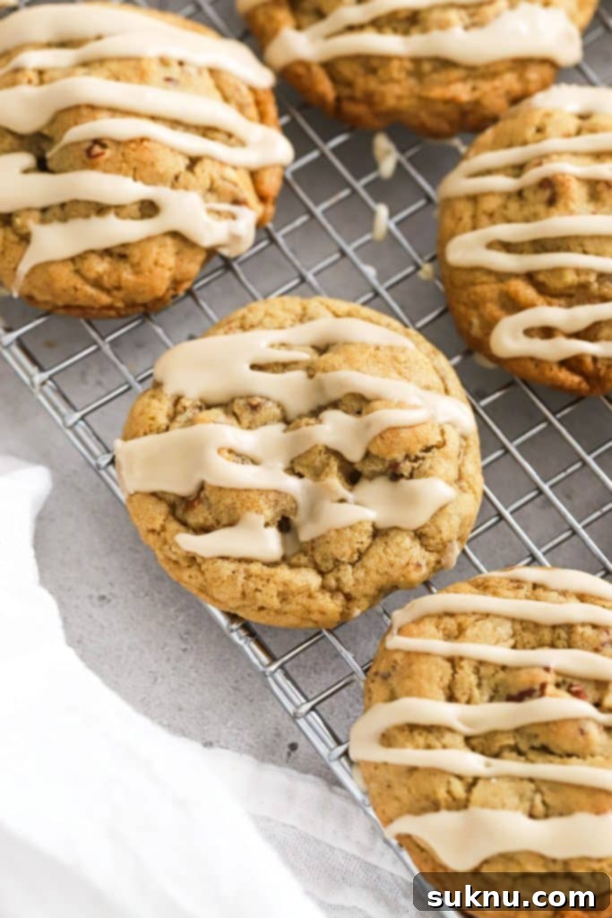 Cozy Fall Gluten-Free Pumpkin Snickerdoodles 11 Gluten-free maple pecan cookies with a sweet maple glaze cooling on a wire rack.