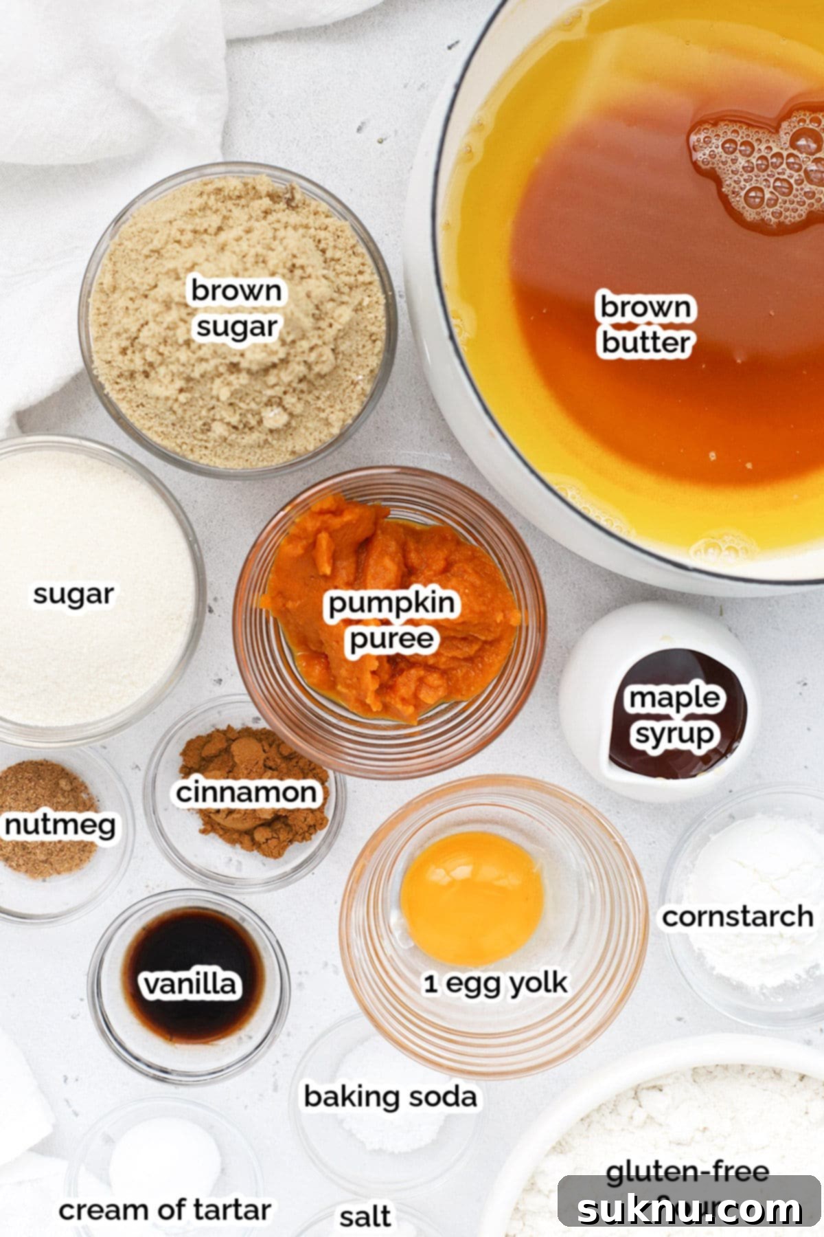 Cozy Fall Gluten-Free Pumpkin Snickerdoodles 3 A flat lay of ingredients for gluten-free pumpkin snickerdoodle cookies, including butter, sugar, pumpkin puree, flour, and spices.