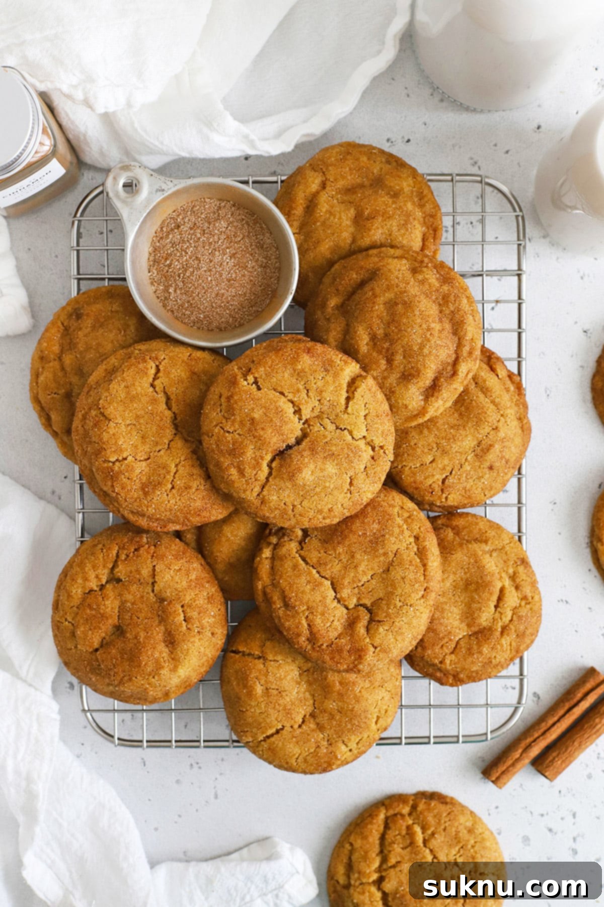 Cozy Fall Gluten-Free Pumpkin Snickerdoodles 6 Close-up of gluten-free pumpkin snickerdoodles cooling on a wire rack, showing their texture and cinnamon sugar coating.
