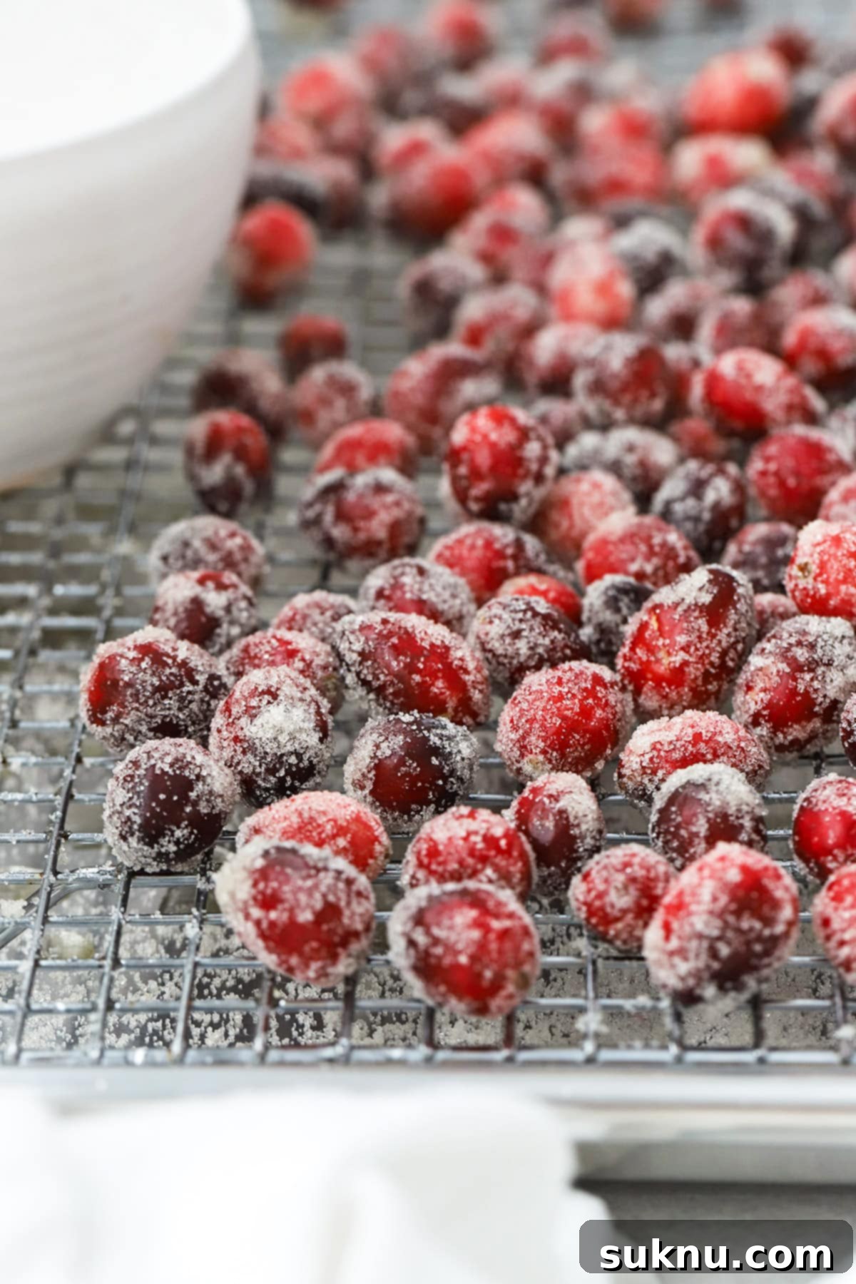 Sparkling Sugared Cranberries 12 Front view of sugar covered cranberries on a wire rack