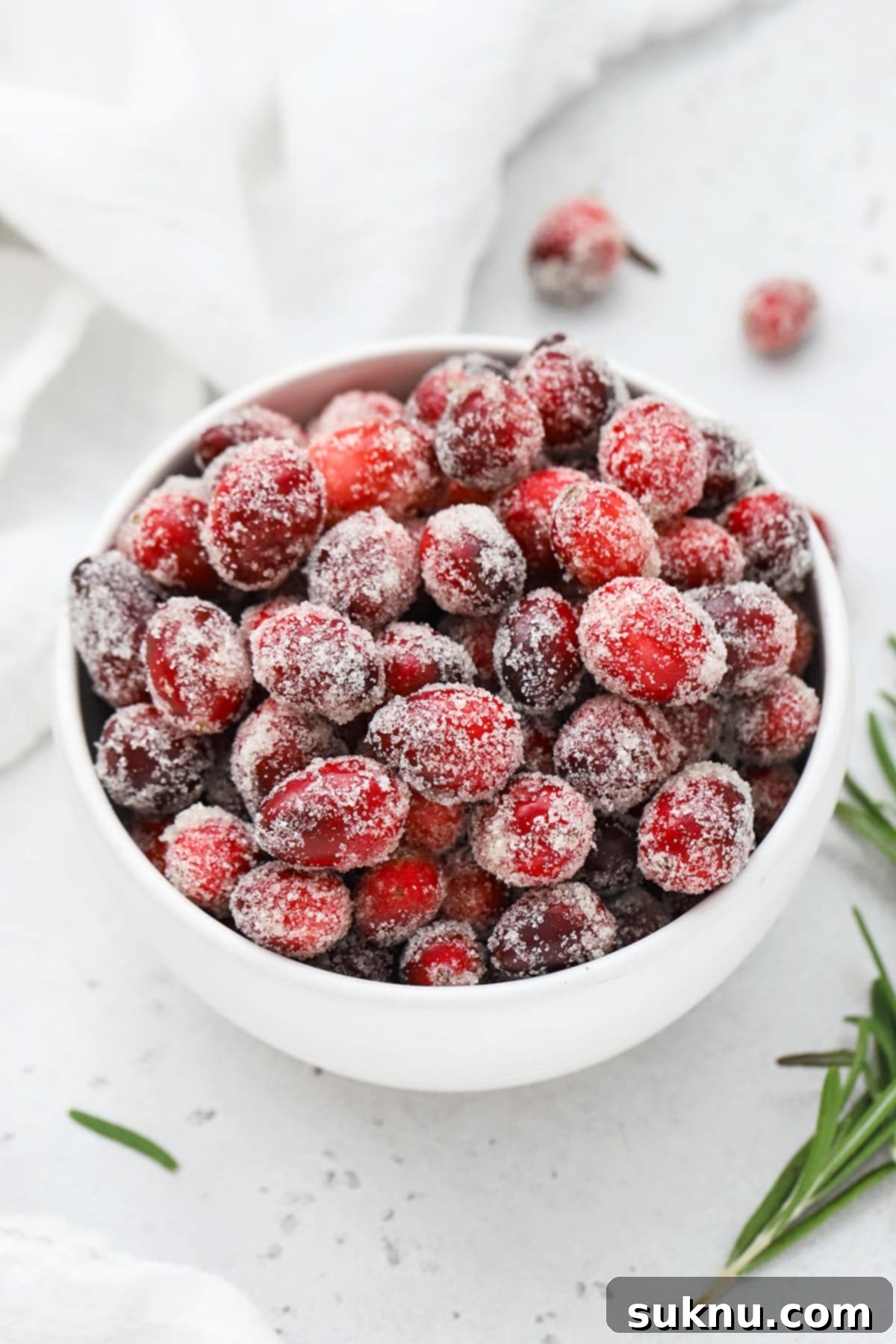 Sparkling Sugared Cranberries 13 Front view of a white bowl of candied cranberries covered with sugar