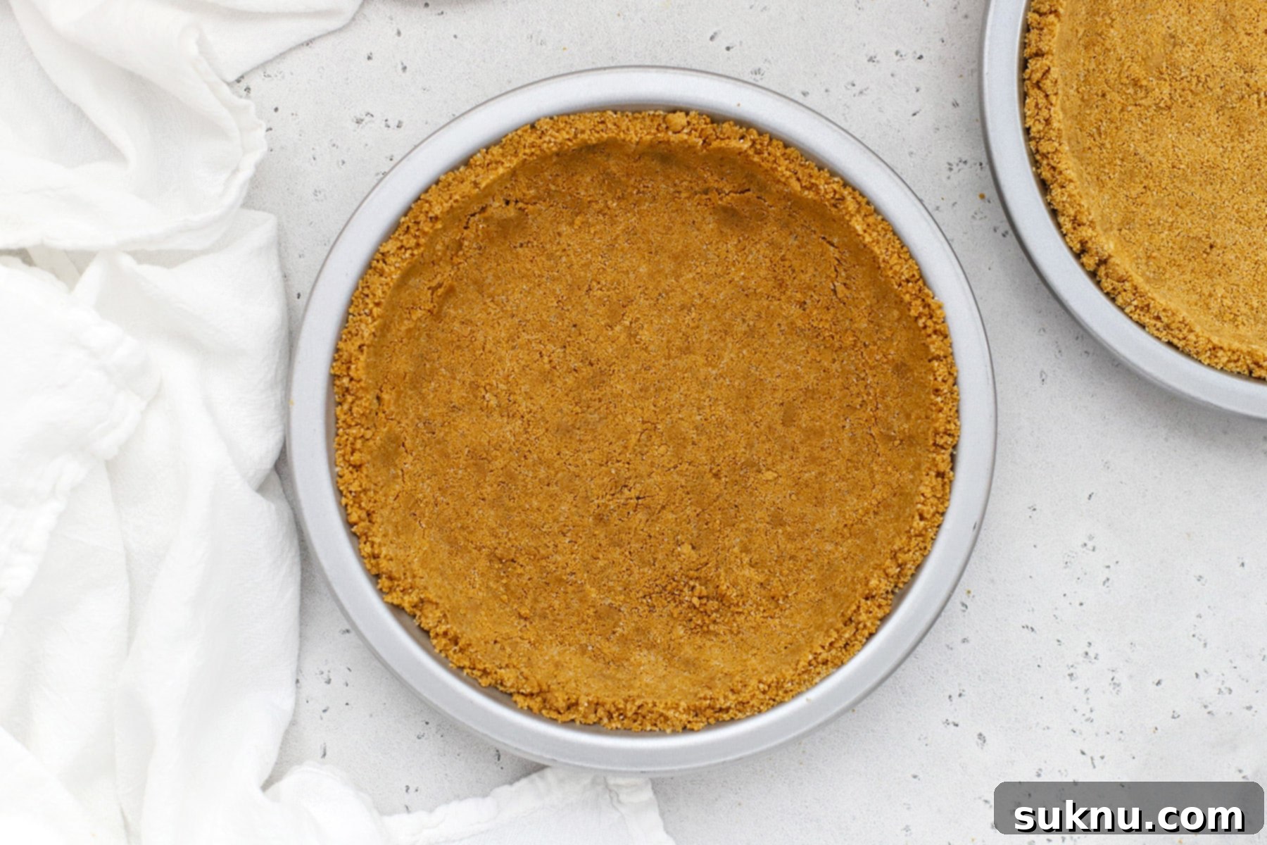 Gluten-free graham cracker crust in a metal pie plate