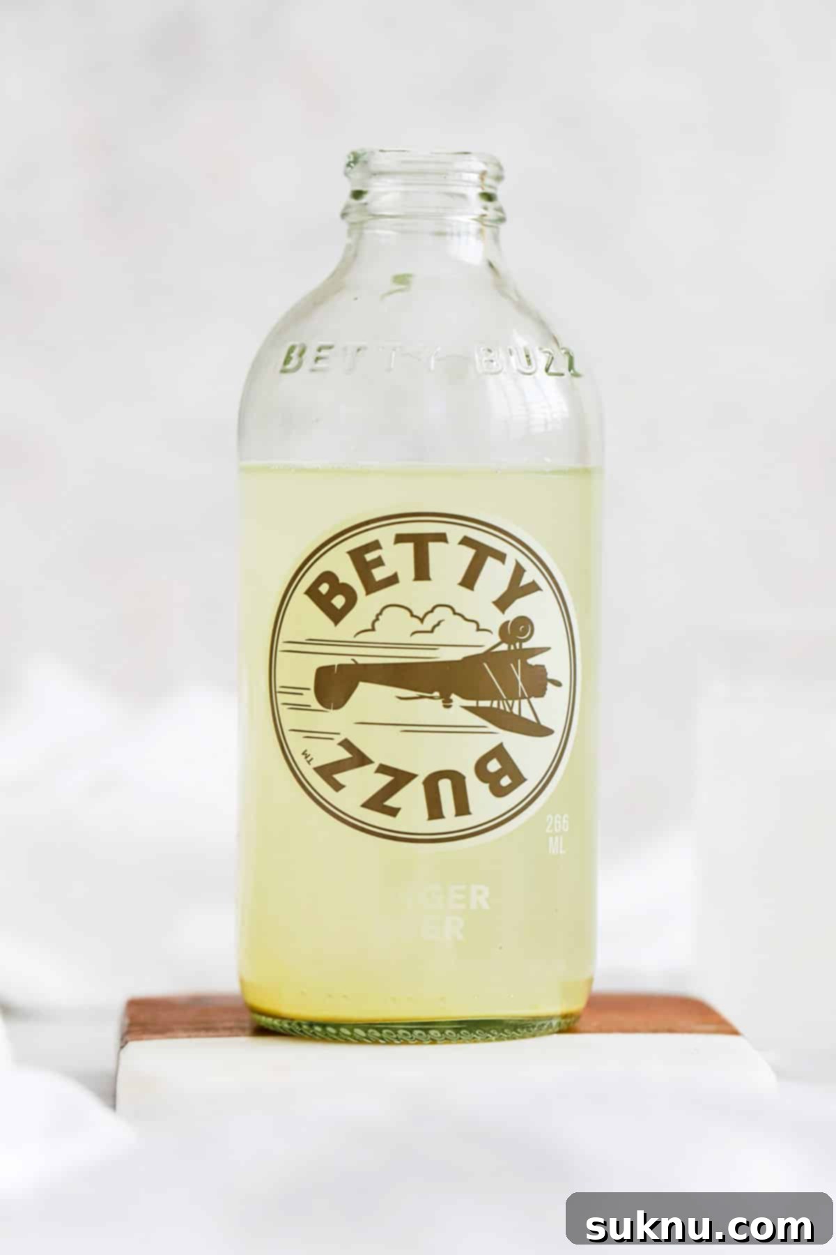 front view of a bottle of betty buzz ginger beer