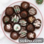 Decadent Gluten-Free Oreo Truffles 12 Gluten-free Oreo truffles decorated with different toppings on a white plate with a red rim