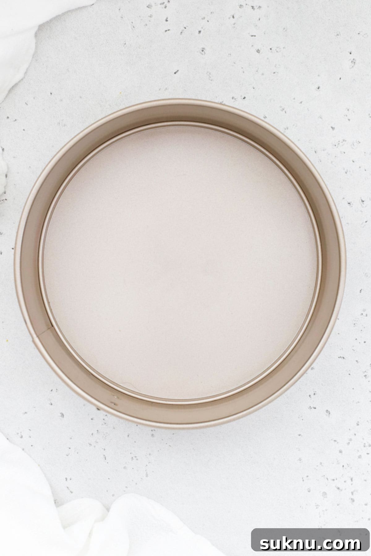 A 9-inch springform pan with its removable side unlatched, showcasing its utility for delicate cheesecakes and tarts.