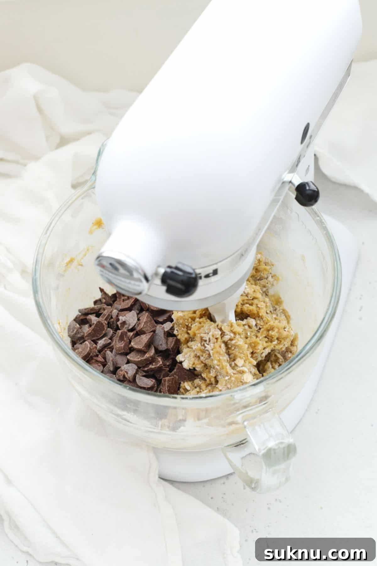 Adding chocolate chips and chopped chocolate to the gluten-free oatmeal chocolate chip cookie dough