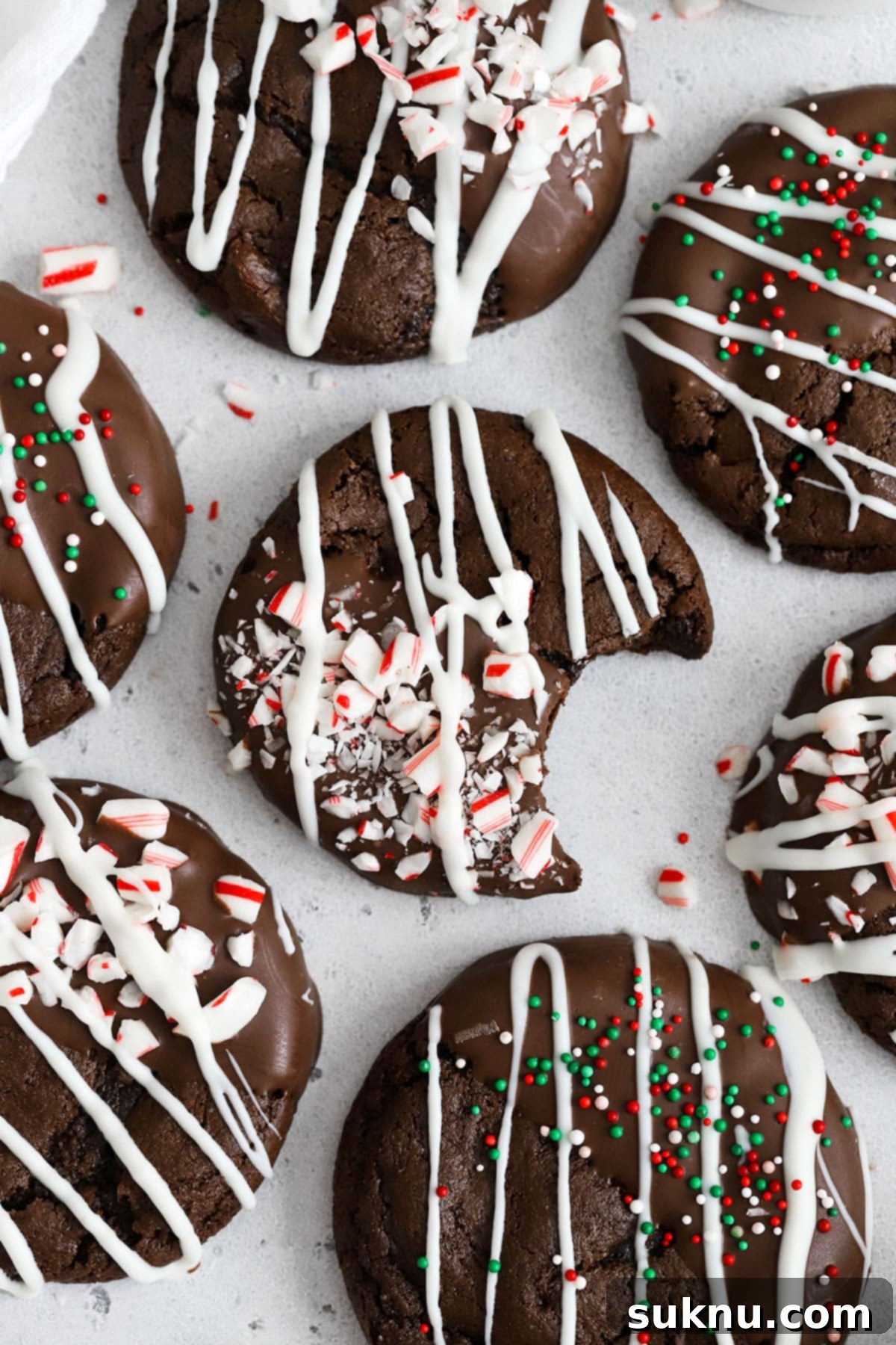 A festive stack of gluten-free chocolate candy cane cookies on a white background
