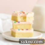 Perfect Gluten-Free Sugar Cookie Bars 13 three sugar cookie bars with pink frosting stacked on a white plate