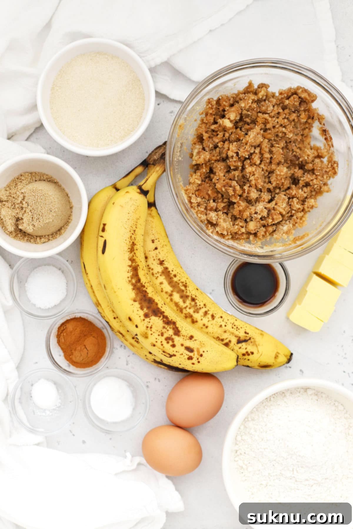 Ingredients for gluten-free banana crumb muffins, including ripe bananas and spices.