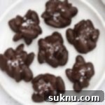 Chocolate almond clusters on a white plate