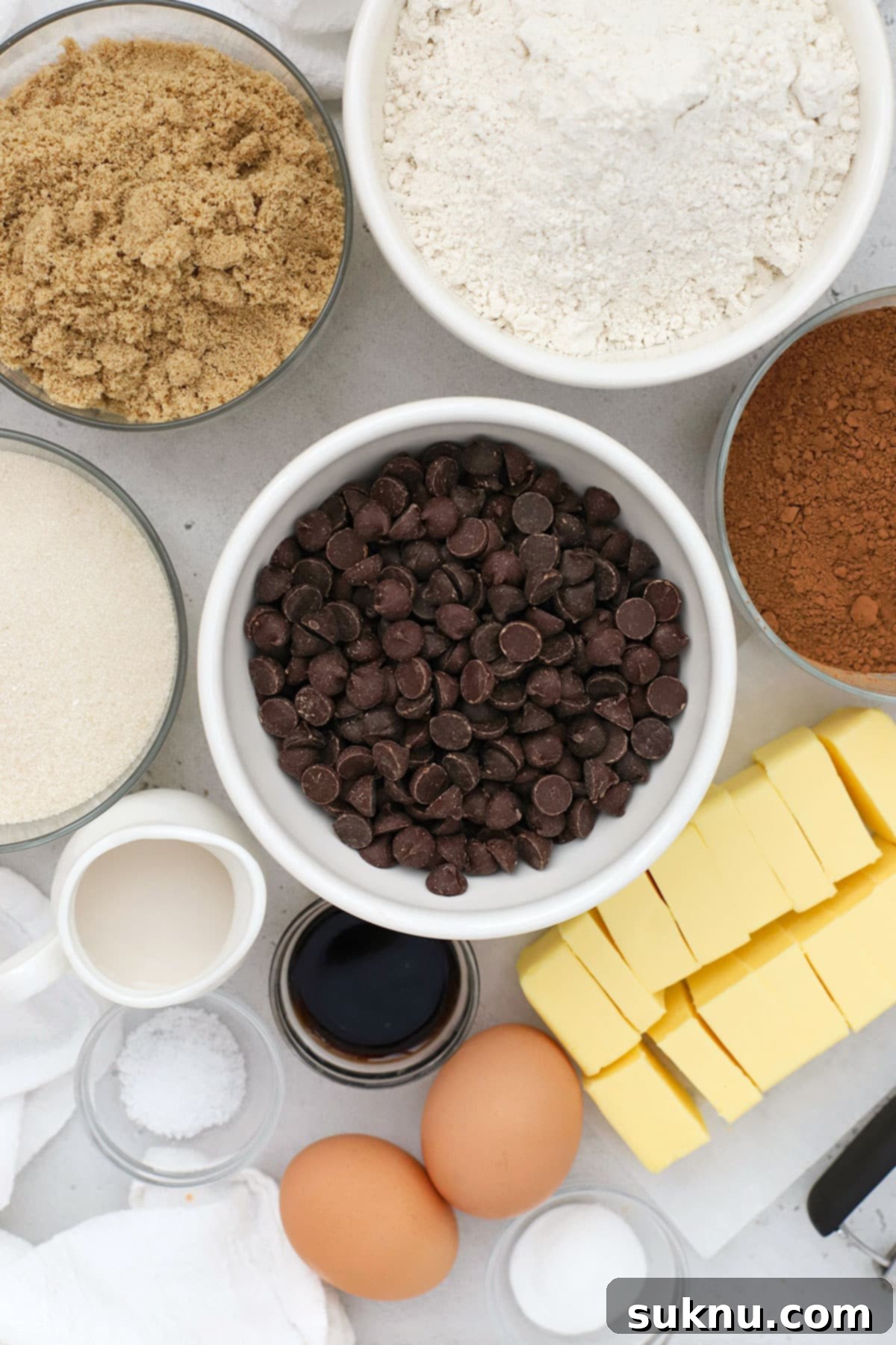 Gluten-Free Double Chocolate Chip Cookies 3 An overhead view showcasing all the essential ingredients laid out on a kitchen counter, ready for making gluten-free chocolate chocolate chip cookies.