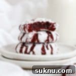 Irresistible Gluten-Free Red Velvet Crinkle Cookies 11 gluten-free red velvet crinkle cookies stacked on white plates