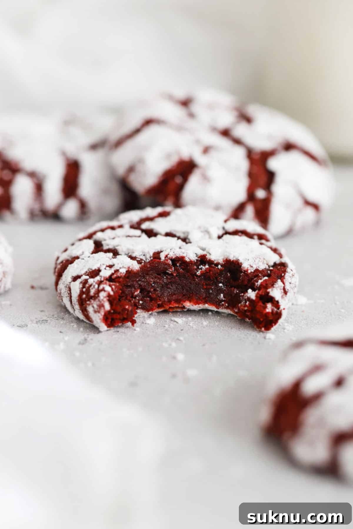 Irresistible Gluten-Free Red Velvet Crinkle Cookies 6 gluten-free red velvet crinkle cookie with a bite taken out of it