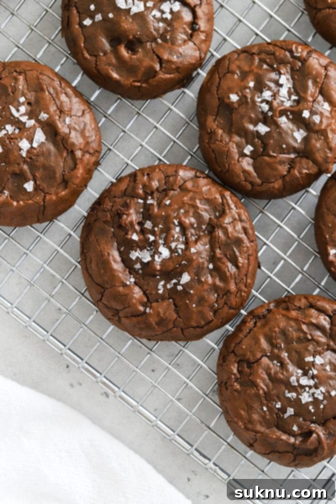 Irresistible Gluten-Free Red Velvet Crinkle Cookies 8 Overhead view of fudgy gluten-free brownie cookies on a cooling rack