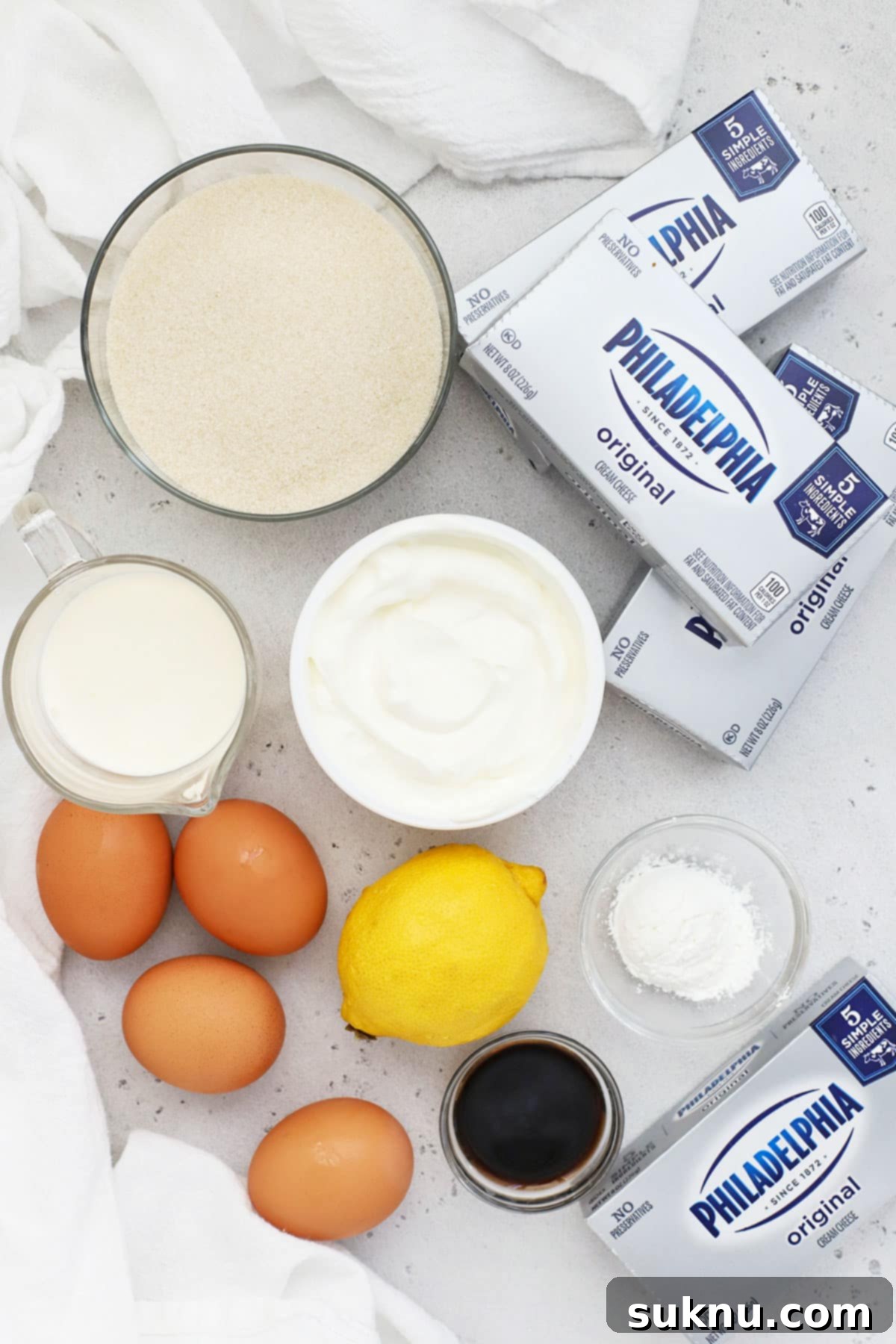 Ingredients laid out for making gluten-free strawberry cheesecake
