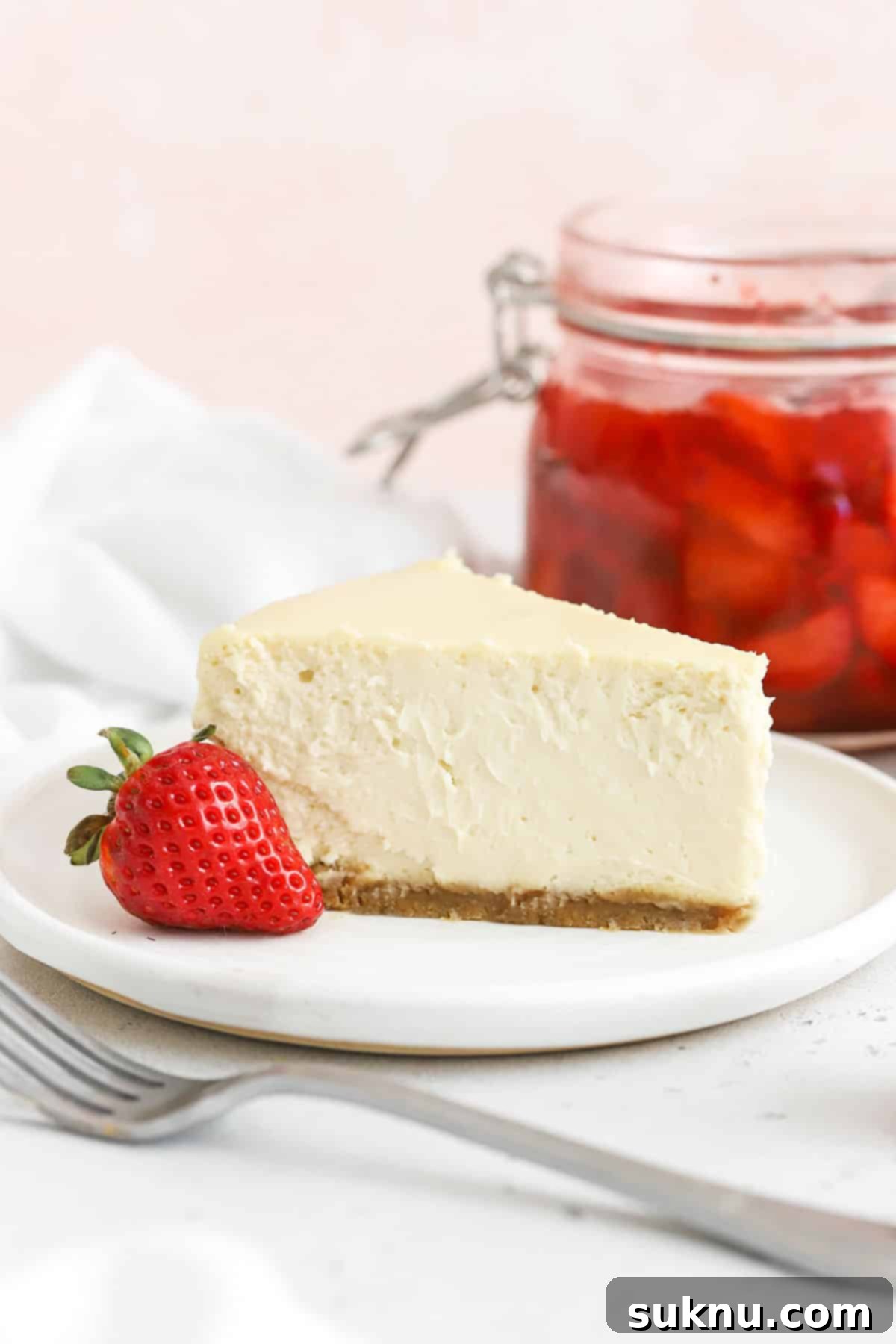 Gluten-free cheesecake with strawberry sauce in a springform pan