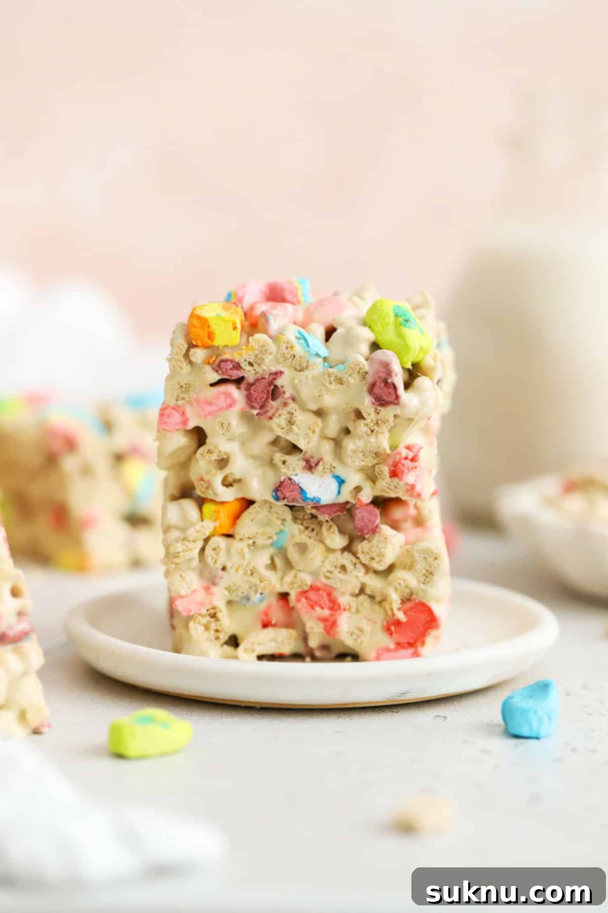 Lucky Charms treats stacked on a white plate, ready to be served