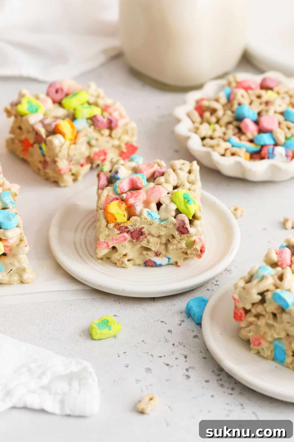 Assorted Lucky Charms treats on white plates, perfect for a party