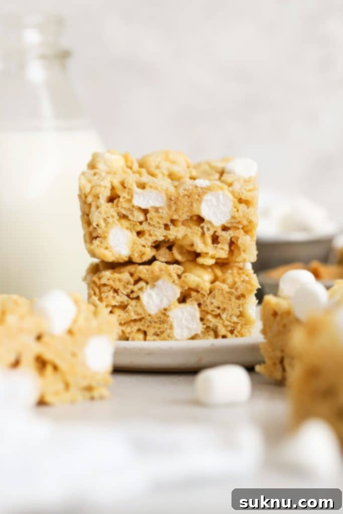 gluten-free peanut butter rice krispie treats stacked on a white plate