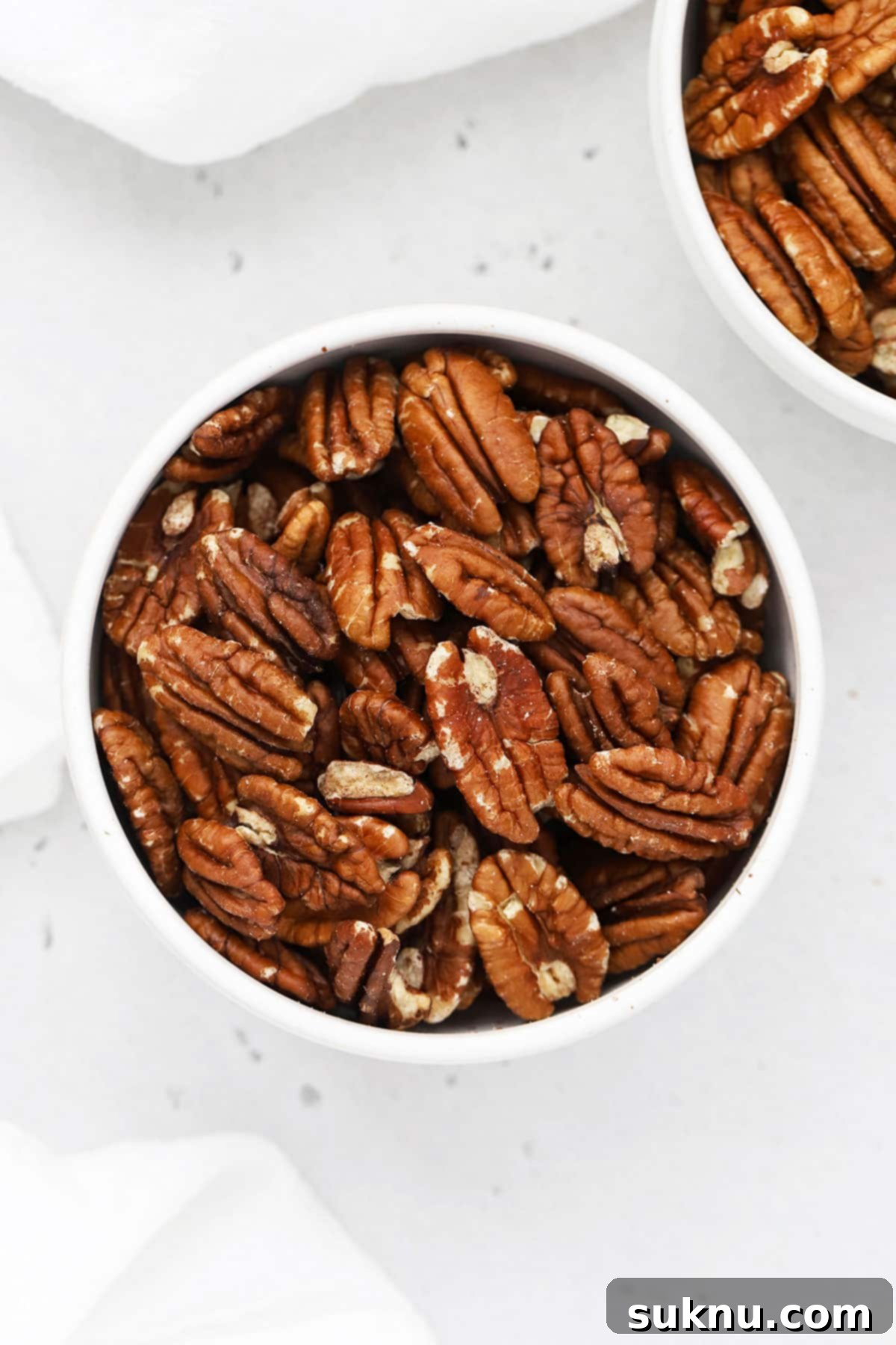 Two bowls of toasted pecans