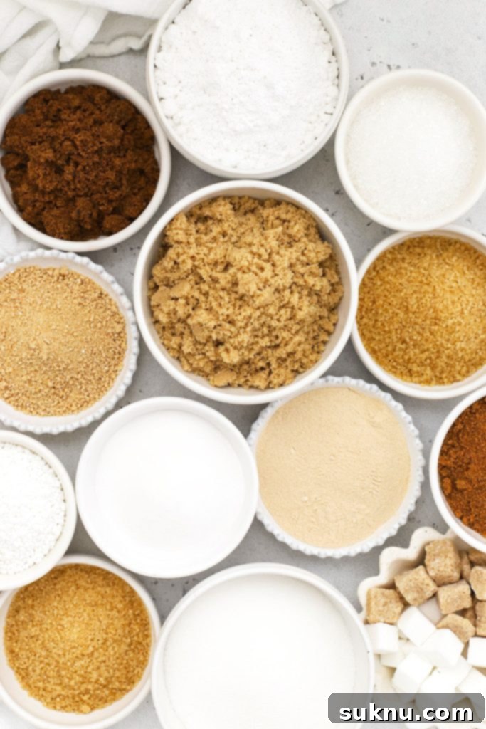 Revive Your Hard Brown Sugar 13 Various kinds of sugar, including granulated, brown, and powdered, presented in small white bowls.