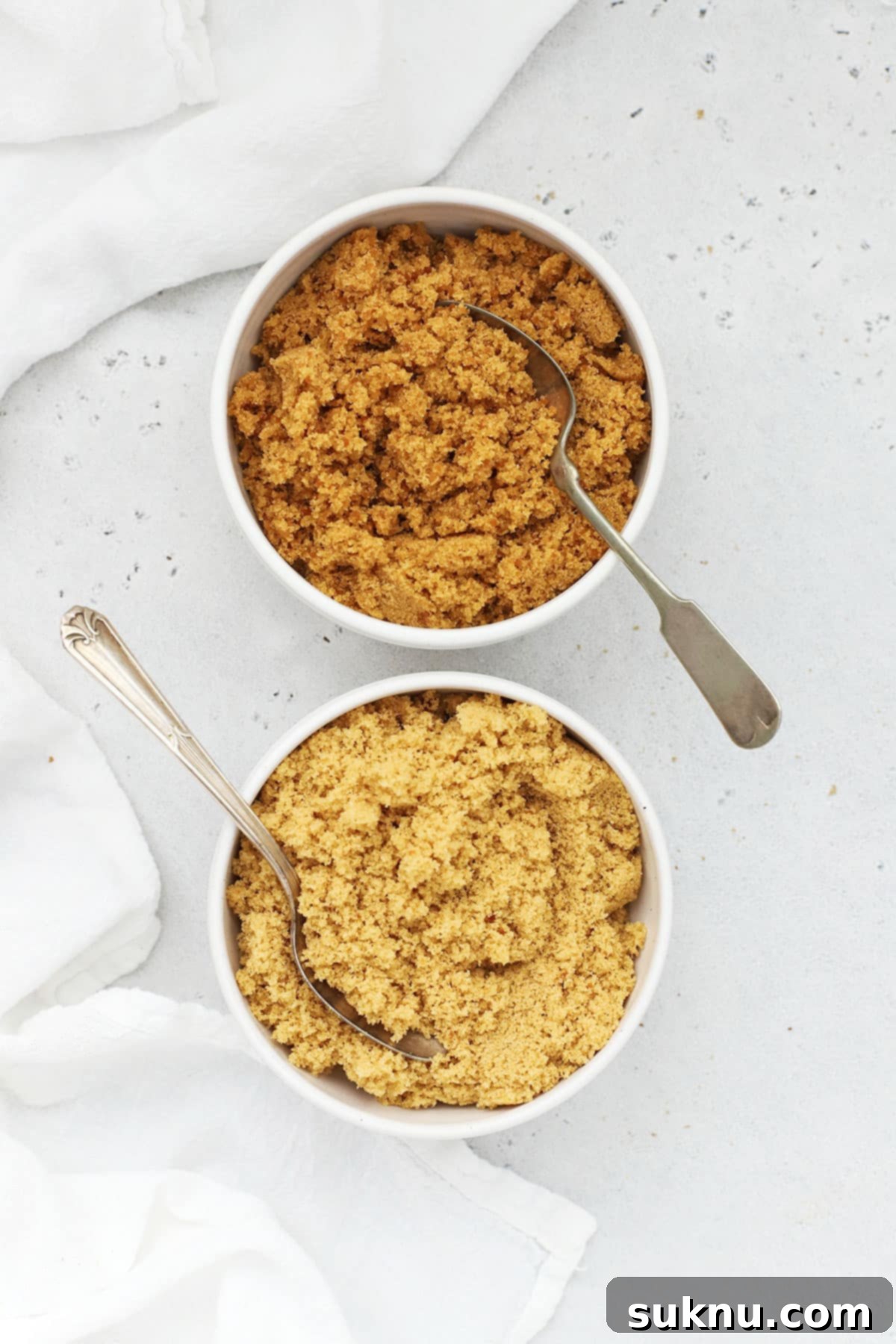 Overhead view of homemade light brown sugar and dark brown sugar in separate bowls
