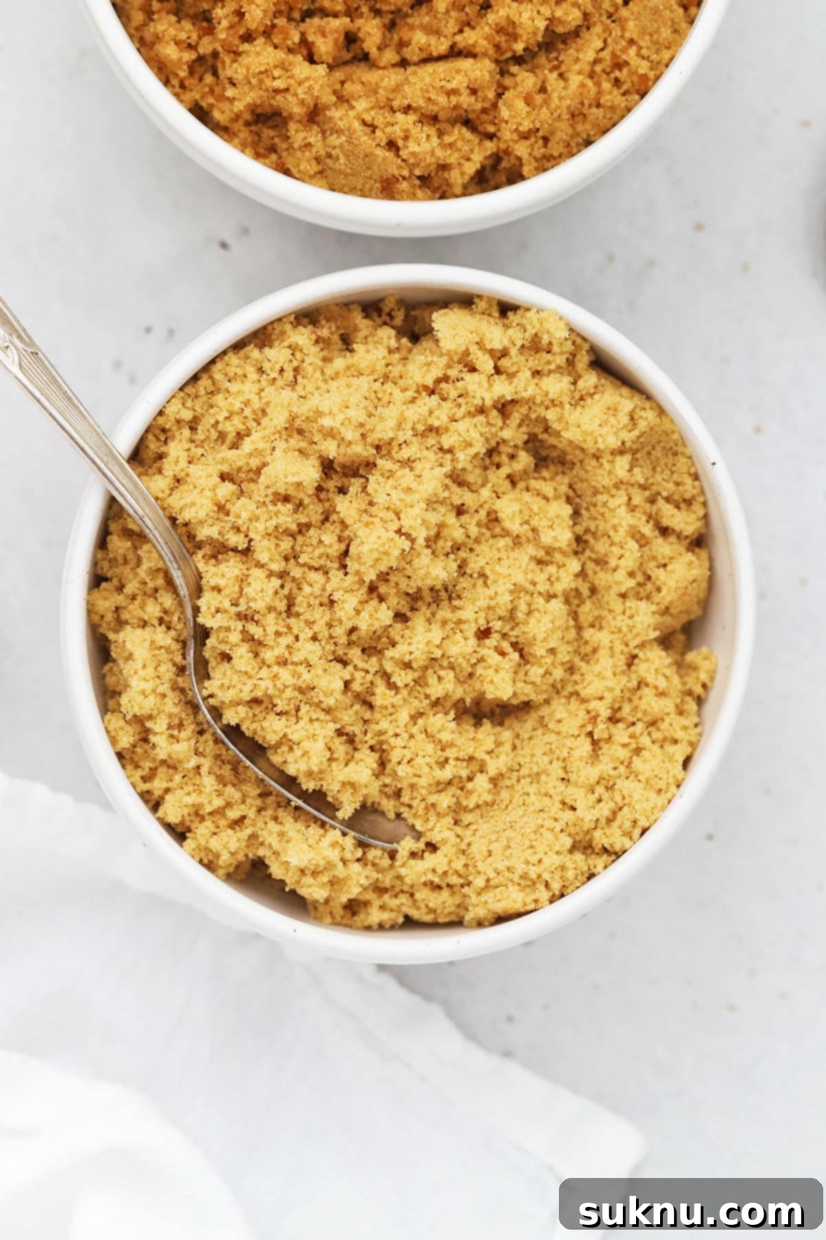 Overhead view of homemade light brown sugar and dark brown sugar in bowls, showcasing the color difference