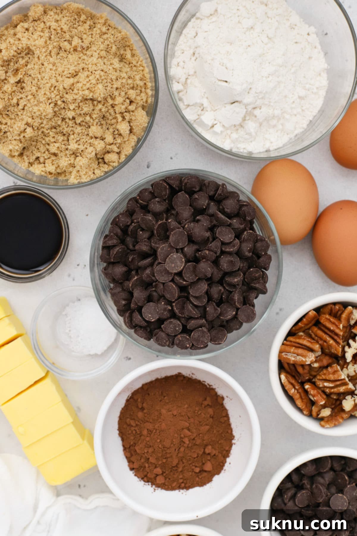 Decadent Gluten-Free Pecan Brownies 3 A flat lay photograph showcasing all the ingredients required for baking gluten-free pecan brownies, neatly arranged on a counter.